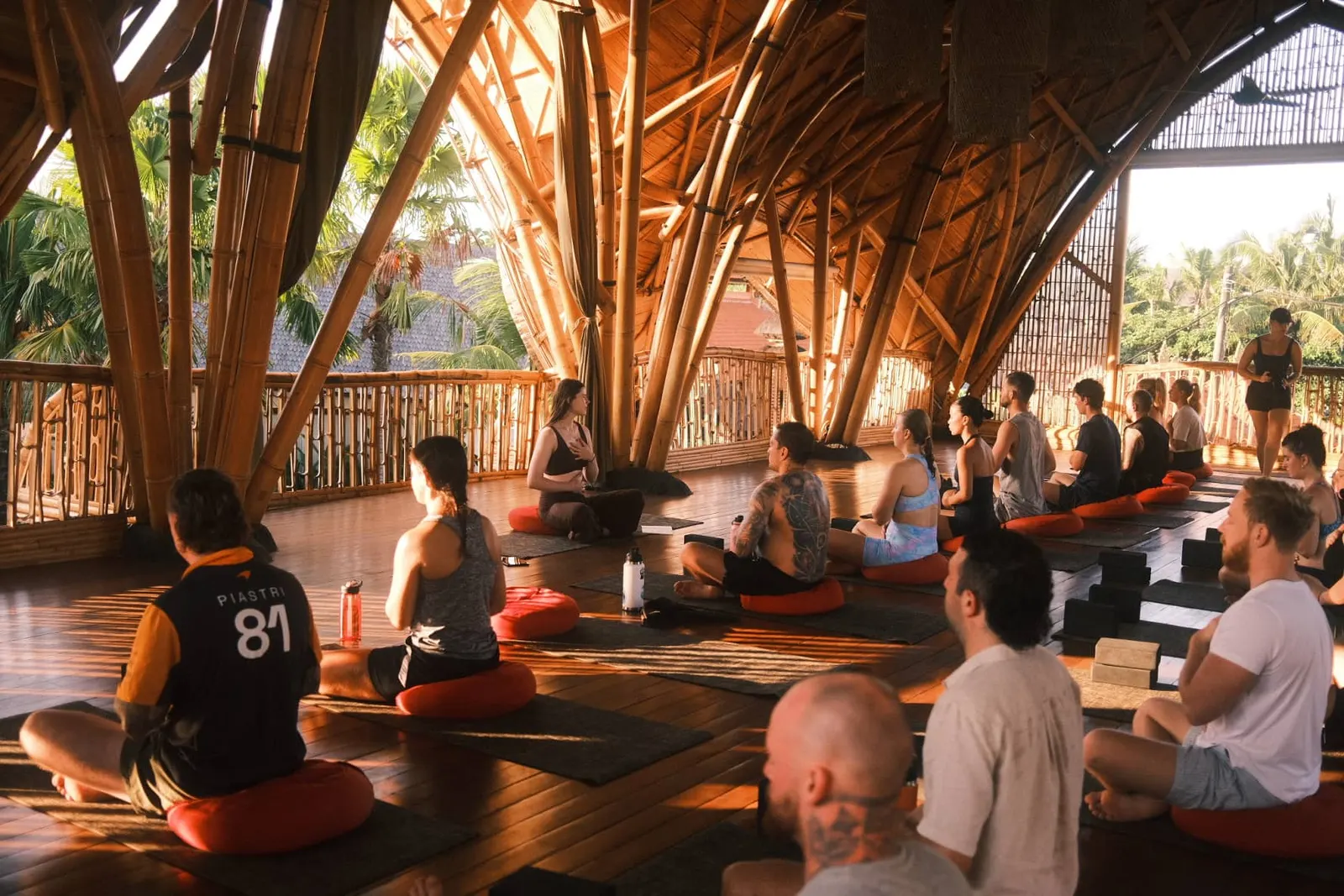Founders in a sunrise yoga session inside the bamboo shala